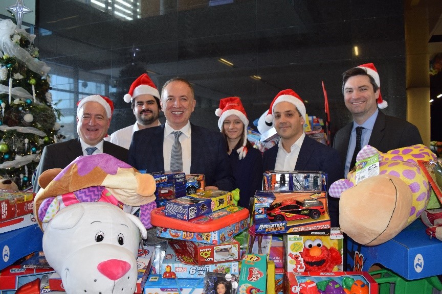 Loopstra-Nixon-team-members-donating-toys-to-CP24-CHUM-Christmas-Wish-Program